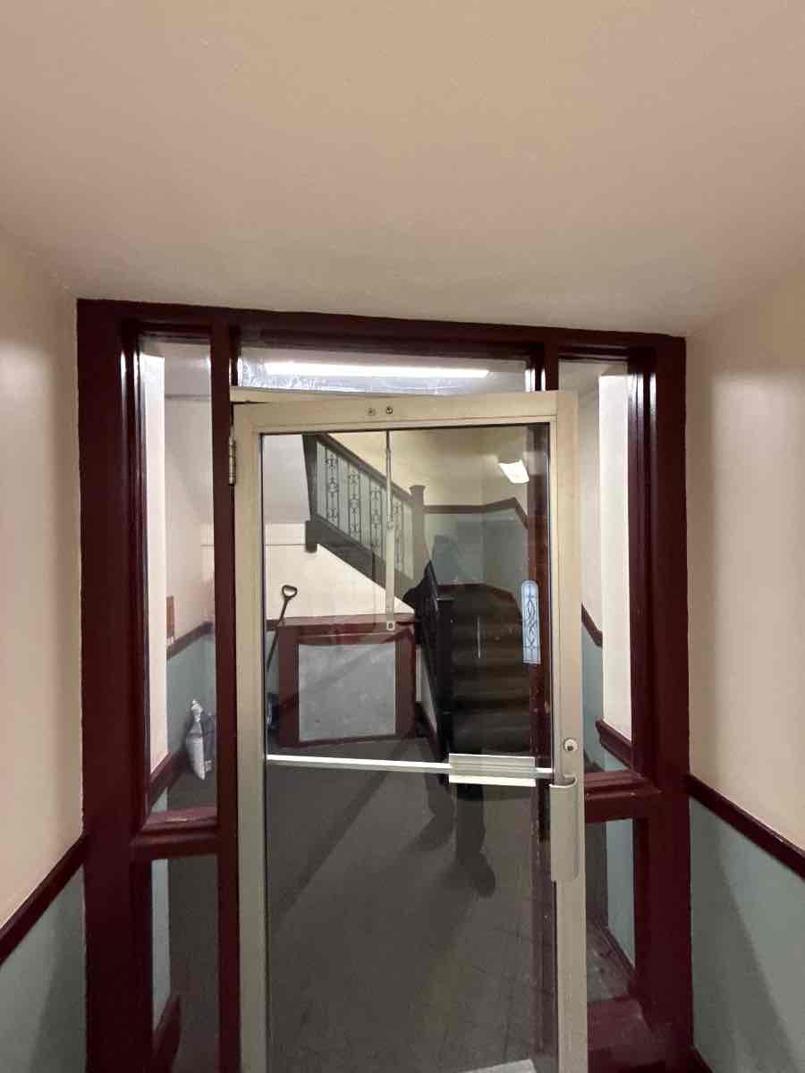 Common-entry door in a Boston apartment building, back in working order. Access was by lockbox — the owner never had to be on site.
