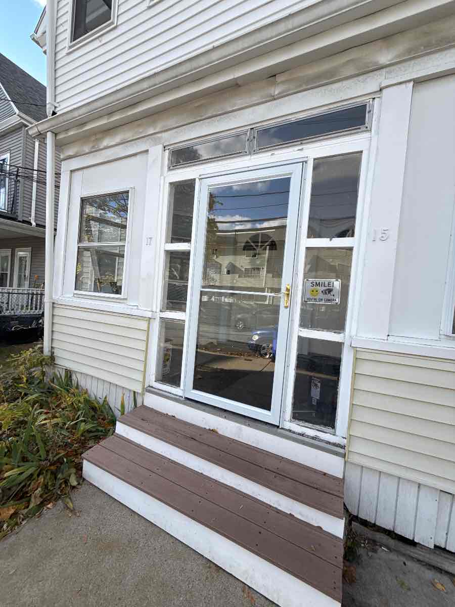 The finished entry door on a Boston two-family, closing and latching properly again.