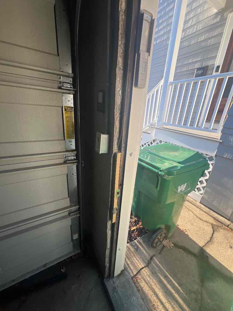 Checking the hinge jamb for plumb with a level and shimming it straight before the door goes back on. Getting the jamb right is what keeps the fix from coming back.