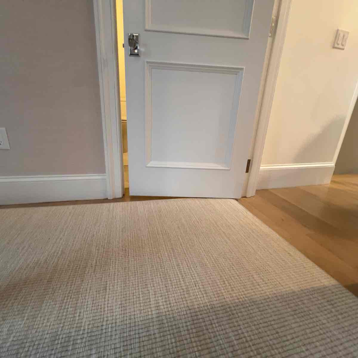 A door shaved down at the bottom so it clears a thick new rug — it now swings freely instead of dragging.