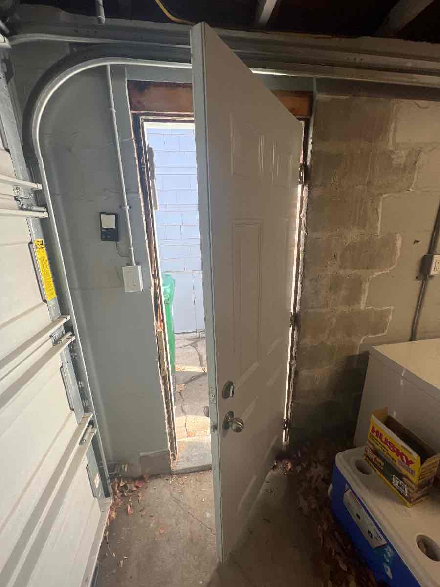The new door hung and swinging true on fresh hinges.